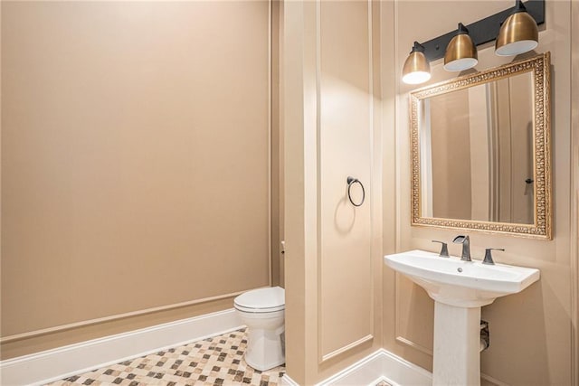 bathroom featuring toilet and tile patterned floors