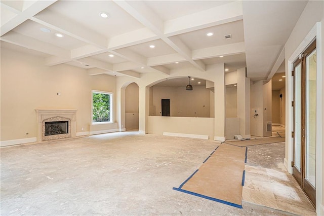 unfurnished living room with coffered ceiling, a premium fireplace, and beamed ceiling