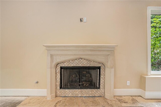 room details featuring a tiled fireplace