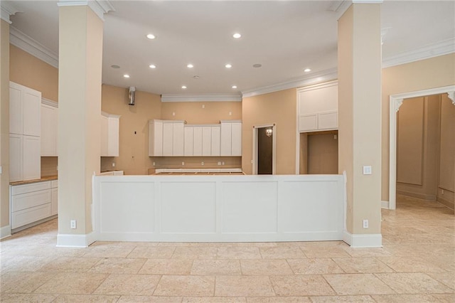 kitchen featuring ornamental molding and white cabinetry