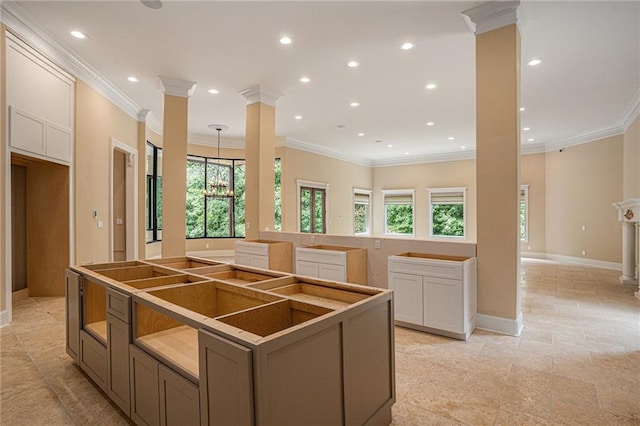kitchen with a kitchen island, crown molding, and a healthy amount of sunlight