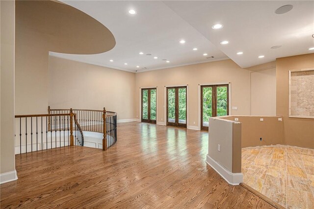 unfurnished room featuring wood-type flooring and ornamental molding