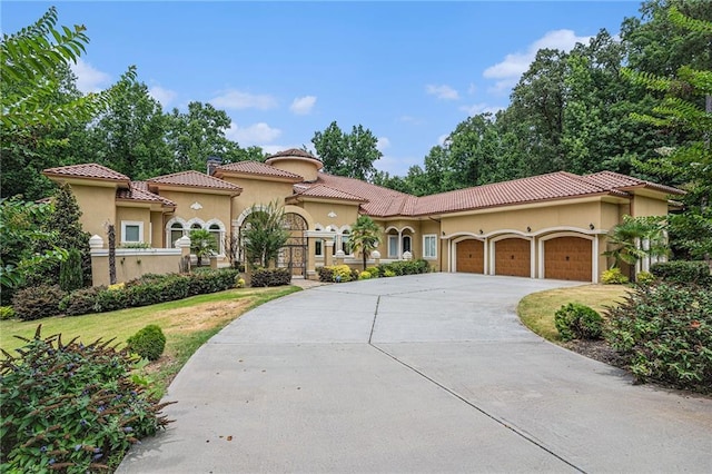 mediterranean / spanish-style house with a front lawn and a garage