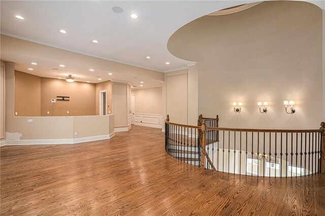 spare room with ornamental molding and wood-type flooring