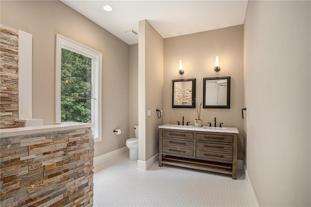 bathroom featuring toilet and vanity