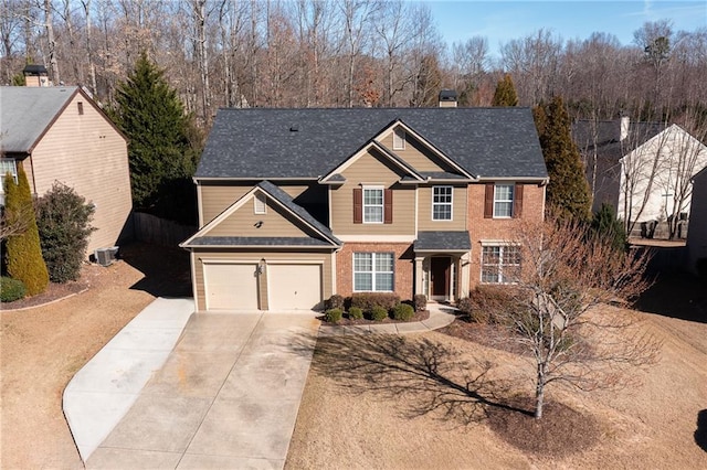 traditional home featuring concrete driveway, brick siding, and a chimney