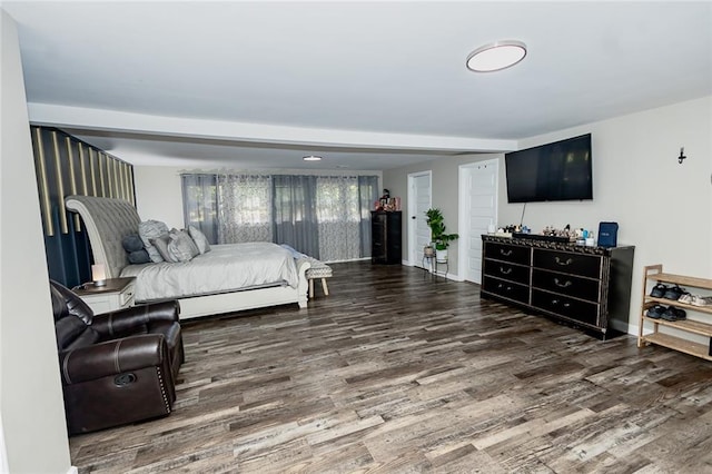 bedroom with dark hardwood / wood-style flooring