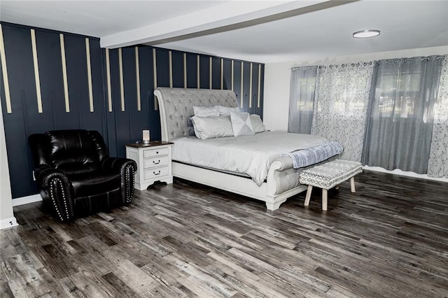 bedroom featuring beamed ceiling and dark wood-type flooring