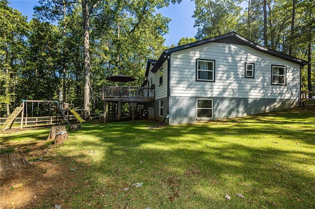 view of property exterior with a playground, a lawn, and a deck