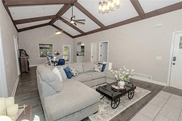 living room with ceiling fan, high vaulted ceiling, beam ceiling, and light hardwood / wood-style flooring