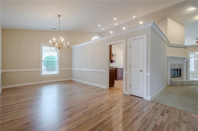 10280 Medridge Cir, Johns Creek, GA 30022 - empty room with lofted ceiling, a chandelier, healthy amount of natural light, a premium fireplace, and light wood finished floors
