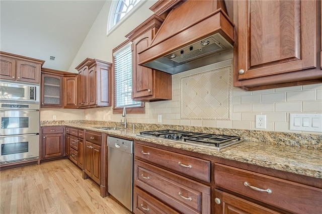 10280 Medridge Cir, Johns Creek, GA 30022 - kitchen with stainless steel appliances, custom exhaust hood, a sink, light stone countertops, and high vaulted ceiling