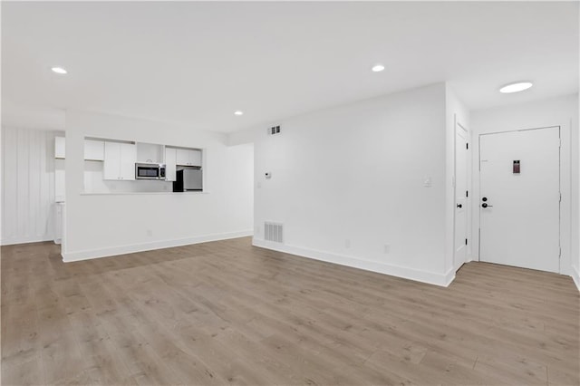 unfurnished living room featuring light hardwood / wood-style floors