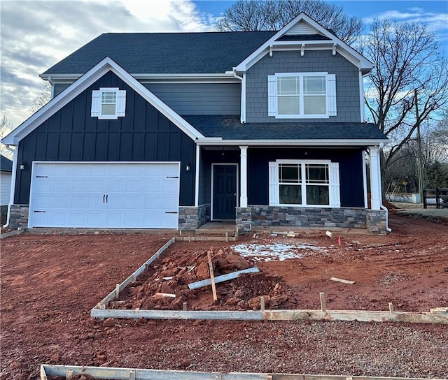 craftsman inspired home featuring a garage and covered porch