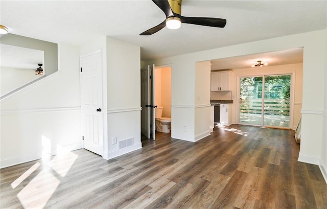 unfurnished living room featuring ceiling fan and hardwood / wood-style flooring