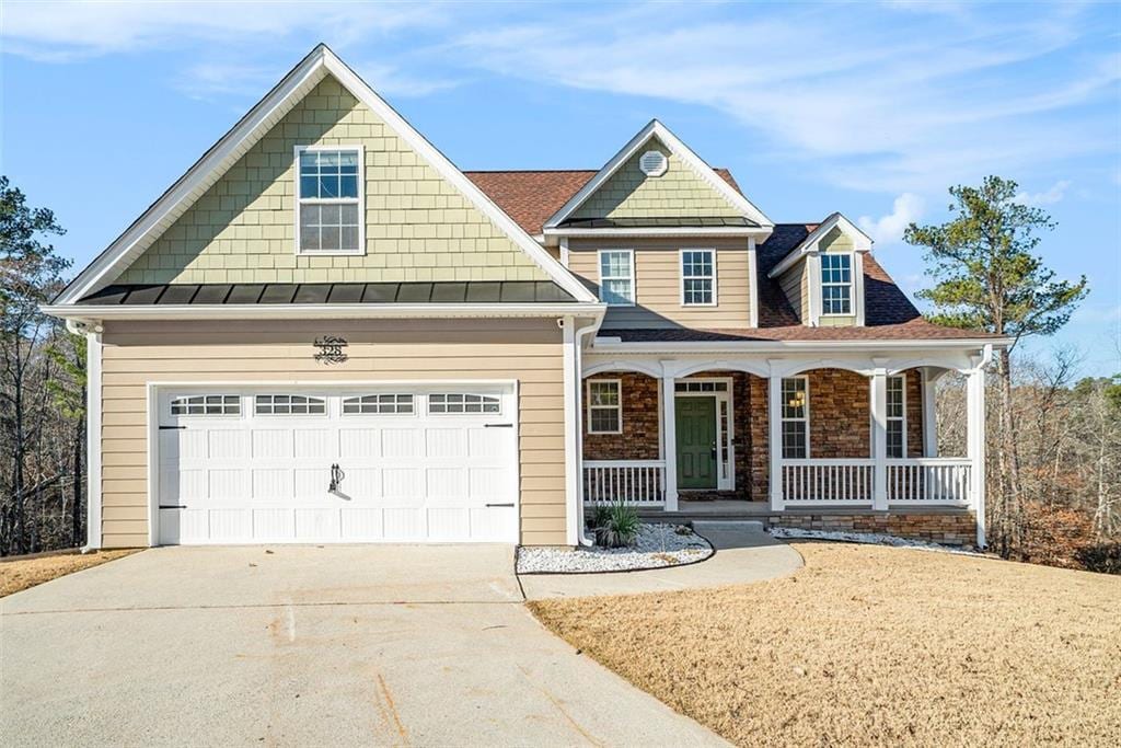 view of front of house featuring covered porch and a garage