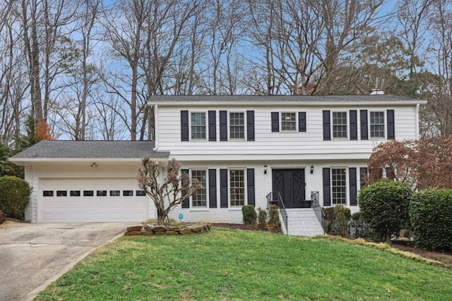 colonial home featuring a garage and a front lawn