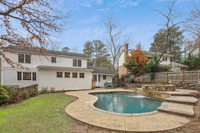 back of house with a fenced in pool, a lawn, a patio, and pool water feature