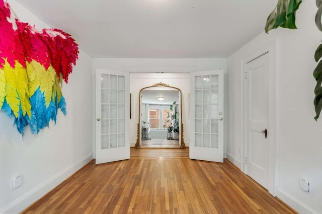 spare room featuring french doors and wood-type flooring