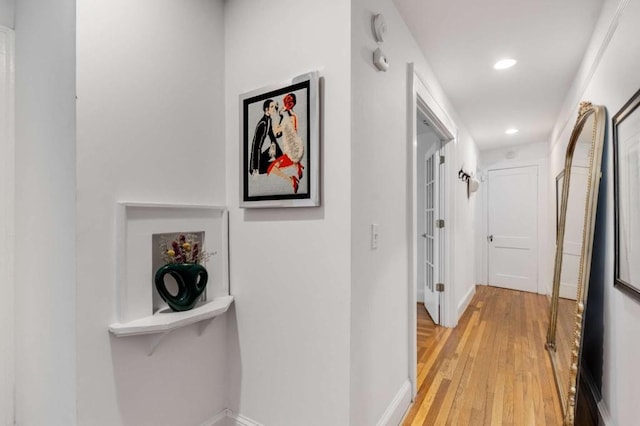 corridor with light hardwood / wood-style flooring