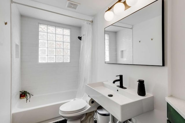 full bathroom with toilet, sink, and shower / bath combo with shower curtain