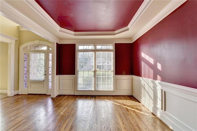 1755 Riverpark Dr, Dacula, GA 30019 - foyer featuring a tray ceiling, wood finished floors, a wainscoted wall, crown molding, and a decorative wall