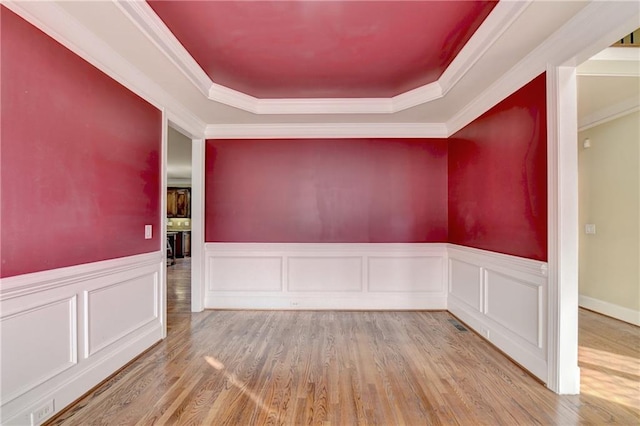 1755 Riverpark Dr, Dacula, GA 30019 - spare room featuring a raised ceiling, wood finished floors, wainscoting, ornamental molding, and a decorative wall