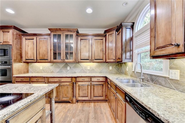 1755 Riverpark Dr, Dacula, GA 30019 - kitchen featuring stainless steel appliances, light stone counters, light wood-style flooring, glass insert cabinets, and crown molding
