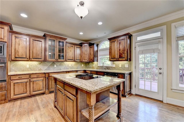 1755 Riverpark Dr, Dacula, GA 30019 - kitchen with stainless steel appliances, healthy amount of natural light, crown molding, light wood-style floors, and brown cabinets