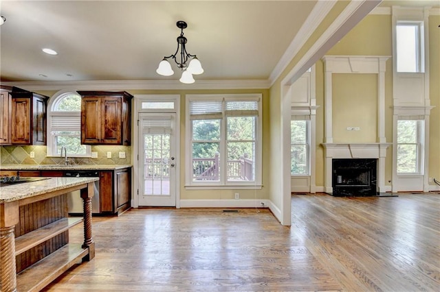 1755 Riverpark Dr, Dacula, GA 30019 - kitchen with stainless steel dishwasher, crown molding, a chandelier, pendant lighting, and healthy amount of natural light