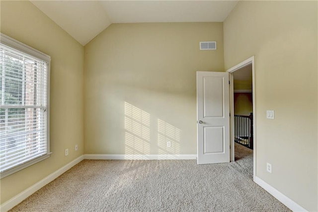 1755 Riverpark Dr, Dacula, GA 30019 - spare room featuring plenty of natural light, carpet flooring, and lofted ceiling