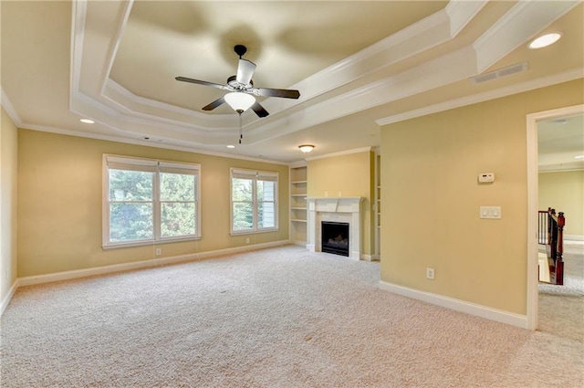 1755 Riverpark Dr, Dacula, GA 30019 - unfurnished living room with a raised ceiling, ceiling fan, carpet flooring, ornamental molding, and a fireplace