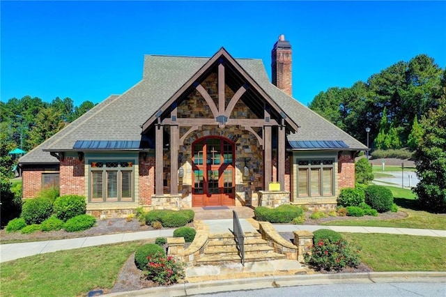 1755 Riverpark Dr, Dacula, GA 30019 - view of front of house with french doors, a chimney, stone siding, and a front lawn