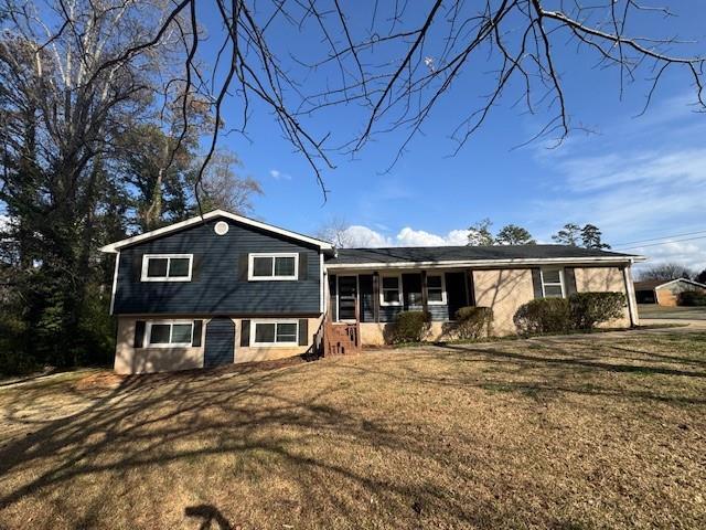 split level home featuring a front lawn