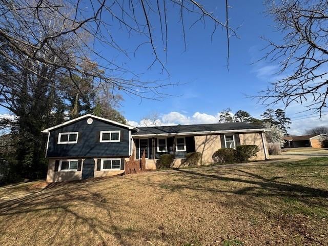 tri-level home with a front lawn