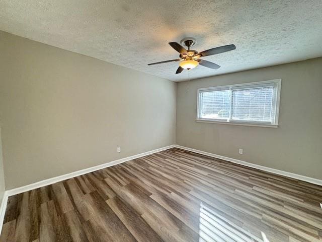 unfurnished room with ceiling fan, baseboards, a textured ceiling, and wood finished floors