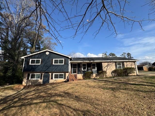 tri-level home with a front yard