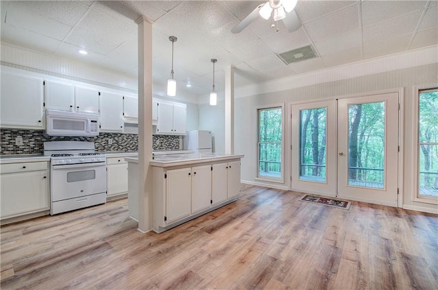 354 Starcross Ln, Jasper, GA 30143 - kitchen featuring white appliances, white cabinets, tasteful backsplash, light countertops, and light wood finished floors