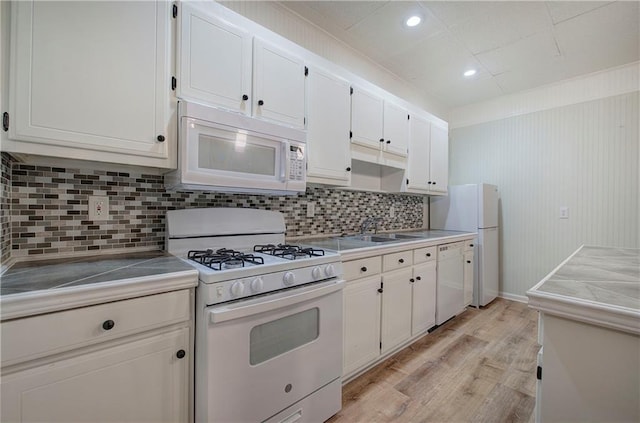 354 Starcross Ln, Jasper, GA 30143 - kitchen with a sink, white appliances, light wood finished floors, decorative backsplash, and white cabinets