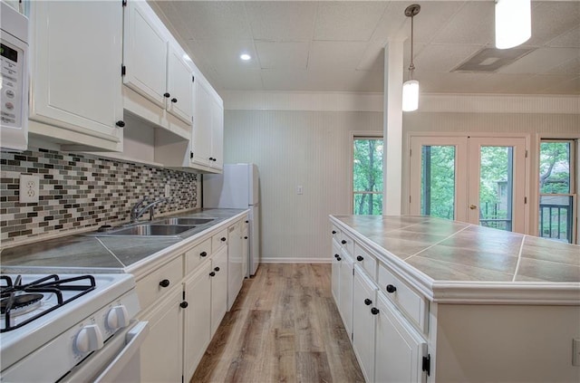 354 Starcross Ln, Jasper, GA 30143 - kitchen featuring white cabinetry, light wood-style floors, plenty of natural light, and decorative backsplash