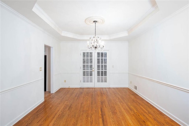 5010 Bonnie Way, Roswell, GA 30075 - unfurnished room featuring a raised ceiling, wood finished floors, a chandelier, ornamental molding, and baseboards