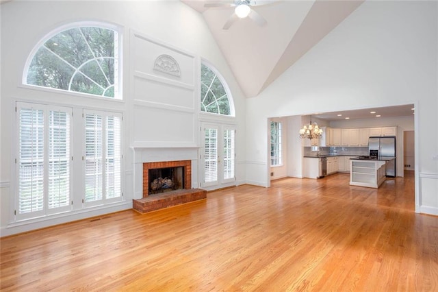 5010 Bonnie Way, Roswell, GA 30075 - unfurnished living room with high vaulted ceiling, a chandelier, light wood finished floors, a brick fireplace, and ceiling fan