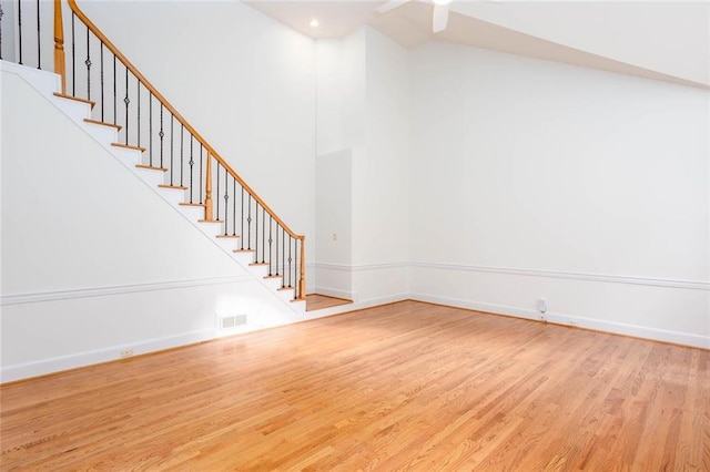 5010 Bonnie Way, Roswell, GA 30075 - unfurnished living room featuring wood finished floors, stairway, baseboards, high vaulted ceiling, and ceiling fan