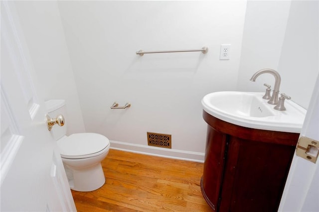 5010 Bonnie Way, Roswell, GA 30075 - half bathroom with vanity, toilet, wood finished floors, and baseboards