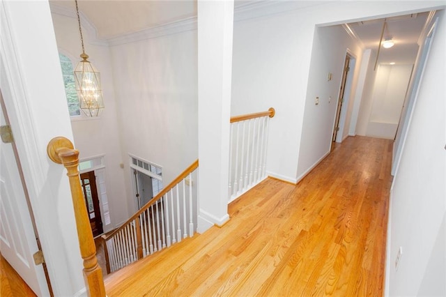 5010 Bonnie Way, Roswell, GA 30075 - corridor featuring an upstairs landing, ornamental molding, a chandelier, and wood finished floors