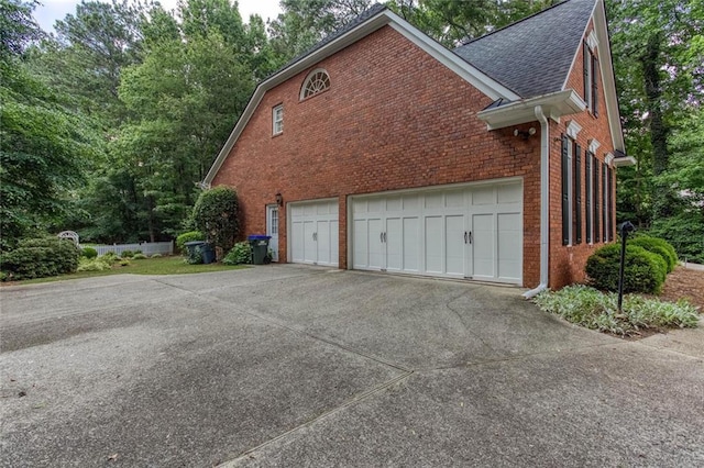 5010 Bonnie Way, Roswell, GA 30075 - view of home's exterior featuring brick siding, driveway, and roof with shingles