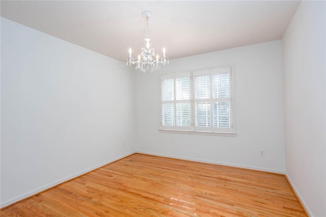 5010 Bonnie Way, Roswell, GA 30075 - spare room with a chandelier, light wood finished floors, and baseboards