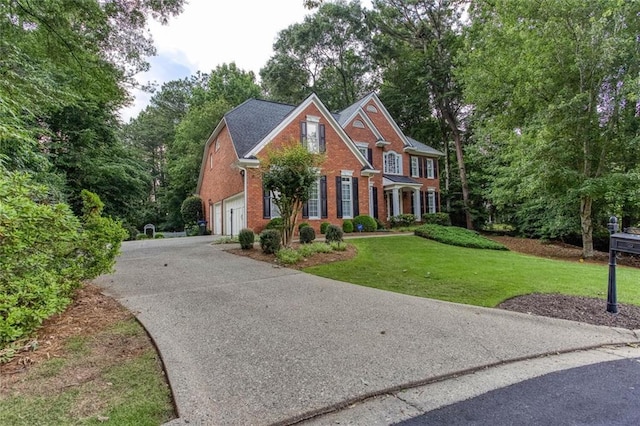 5010 Bonnie Way, Roswell, GA 30075 - view of front facade featuring brick siding, a garage, asphalt driveway, a front lawn, and view of wooded area