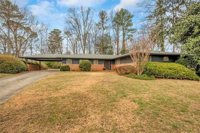 ranch-style house with concrete driveway, an attached carport, and a front yard