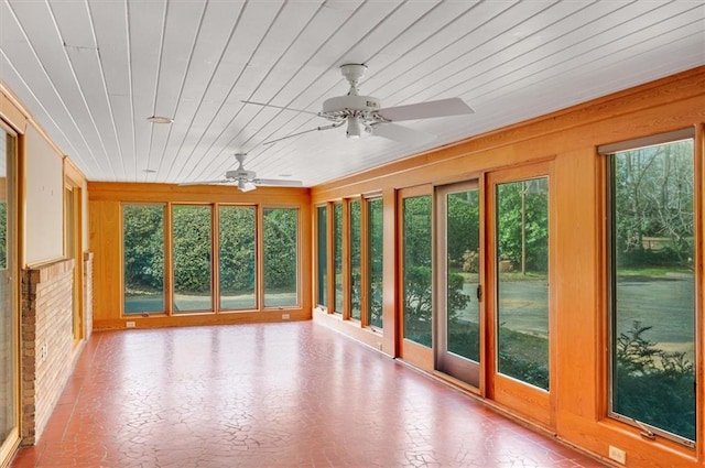 unfurnished sunroom with wood ceiling and a ceiling fan